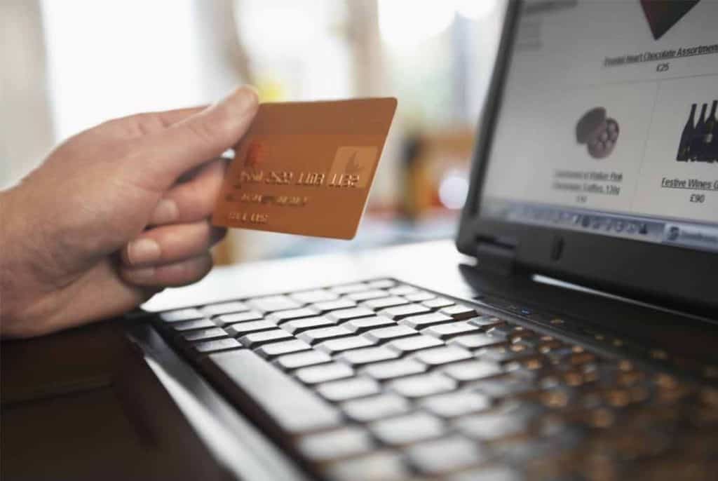 Credit card debt looking at laptop