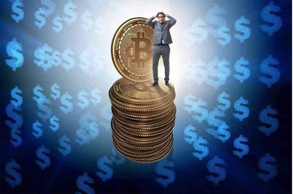 man standing on stack of Bitcoins