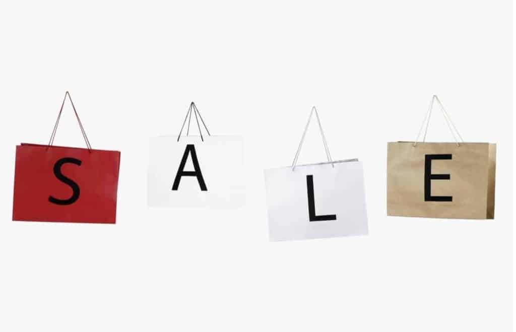 SALE sign on four different bags. 