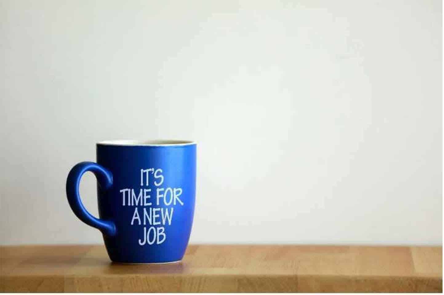 blue mug on brown counter that says it's time for a new job