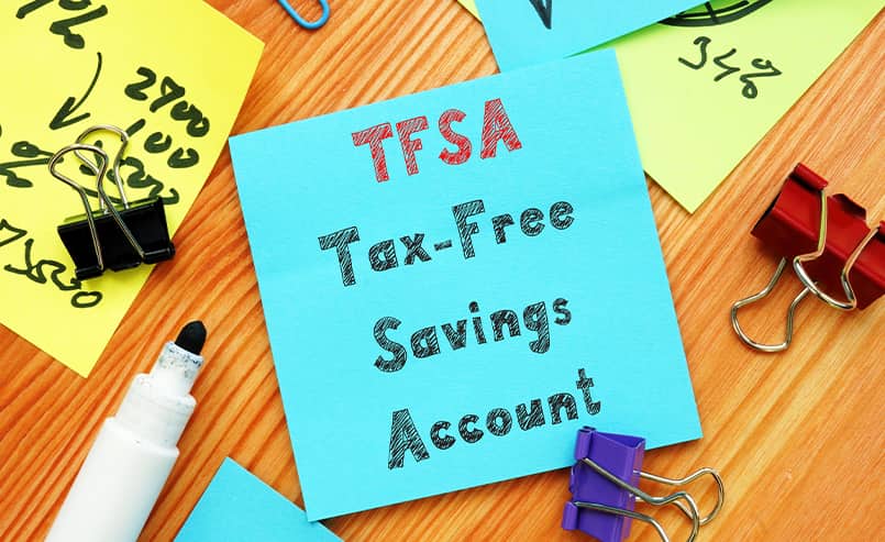 Tax free savings account written out under TFSA on post it note with stationary around it