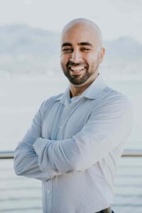 Portrait of Behdad Jamshidi smiling outdoors for SEO.