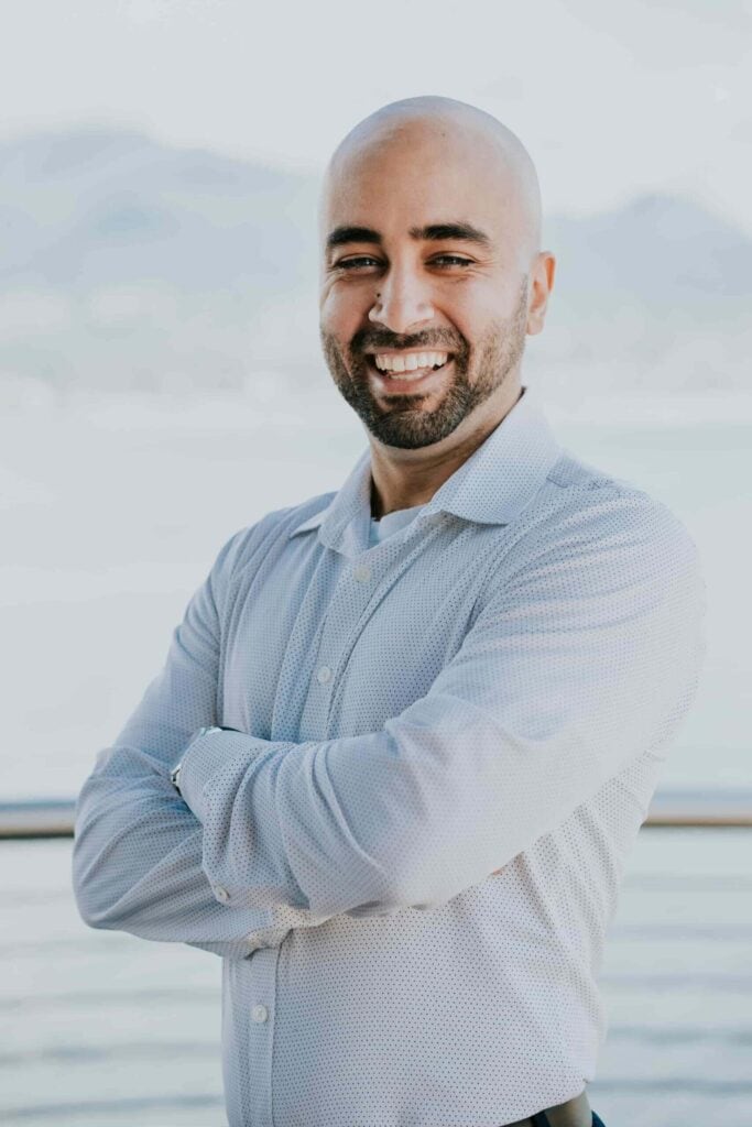 Portrait of Behdad Jamshidi smiling outdoors for SEO.