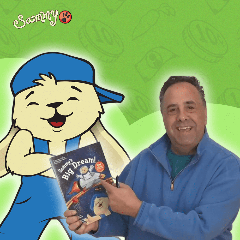 Sammy Rabbit holding a book on financial literacy