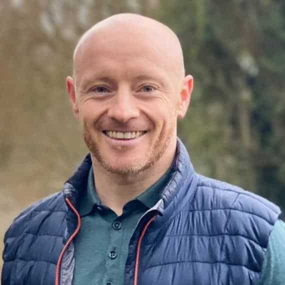 Portrait of Darren Collins, financial literacy educator, smiling outdoors.