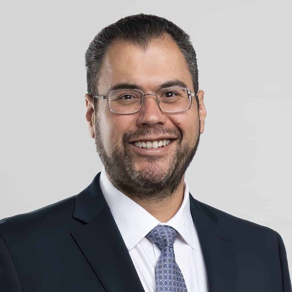 Construction expert Felipe Engineer-Manriquez smiling in a professional suit.