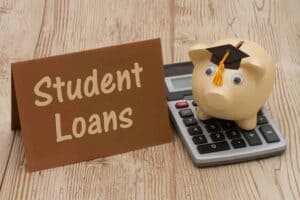 Brown student loan tag with a piggy bank on a calculator with a graduation hat
