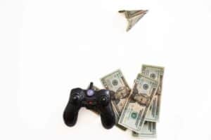 black joystick with u.s. dollars around it and one shaped into an airplane