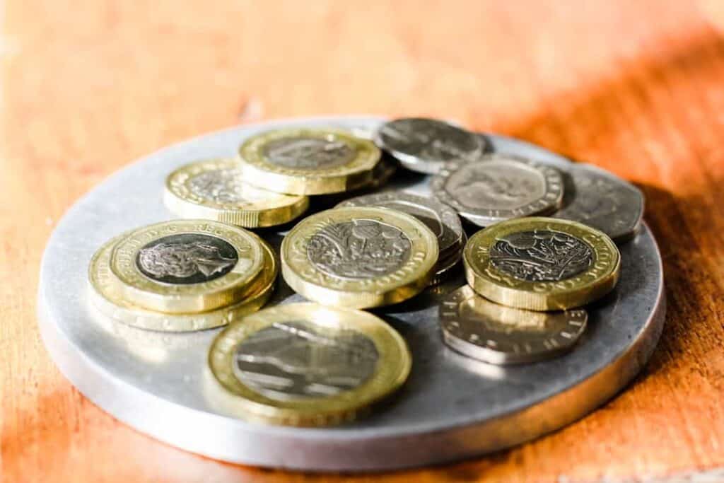 Euro coins stacked on a metal plate for financial or currency concept.