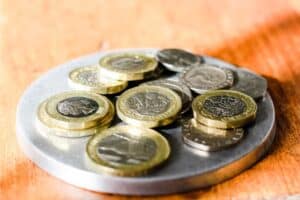 Euro coins stacked on a metal plate for financial or currency concept.